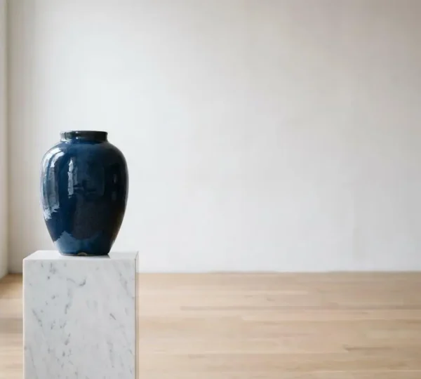 High-end ceramic vase displayed in a professional interior design studio setting with natural lighting