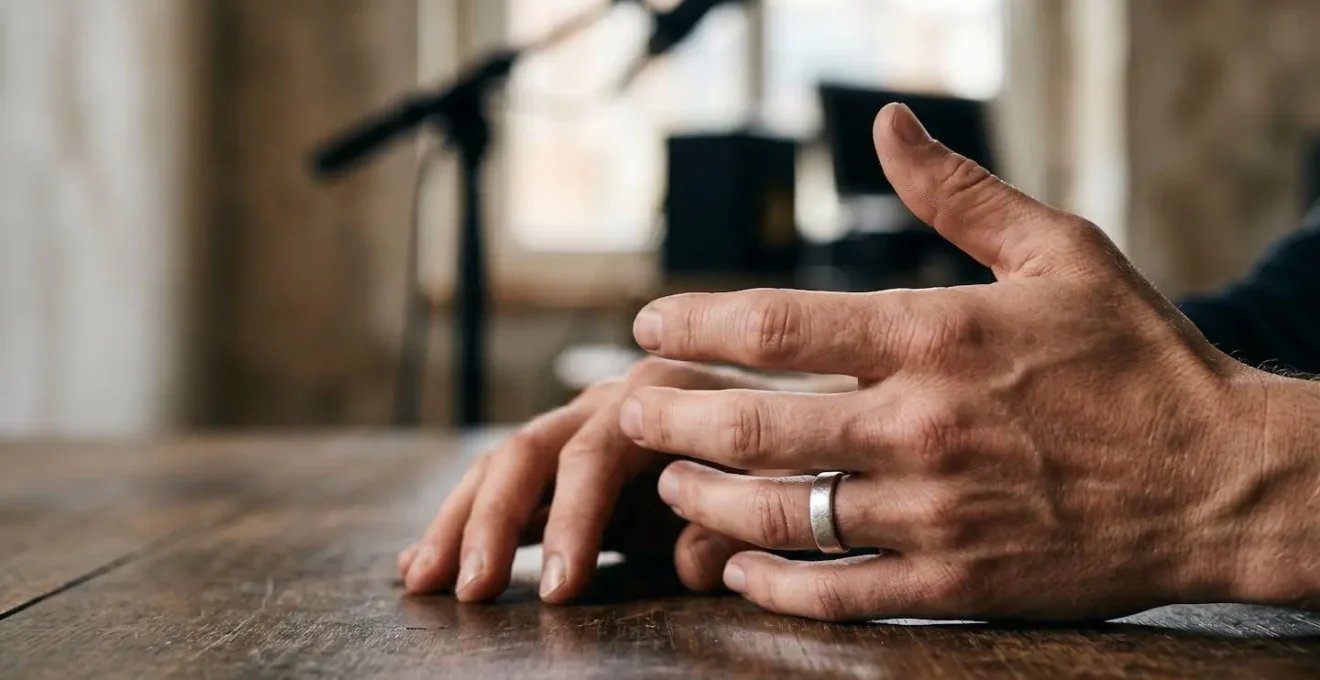Close-up of artist's hands gesturing calmly during tense interview moment