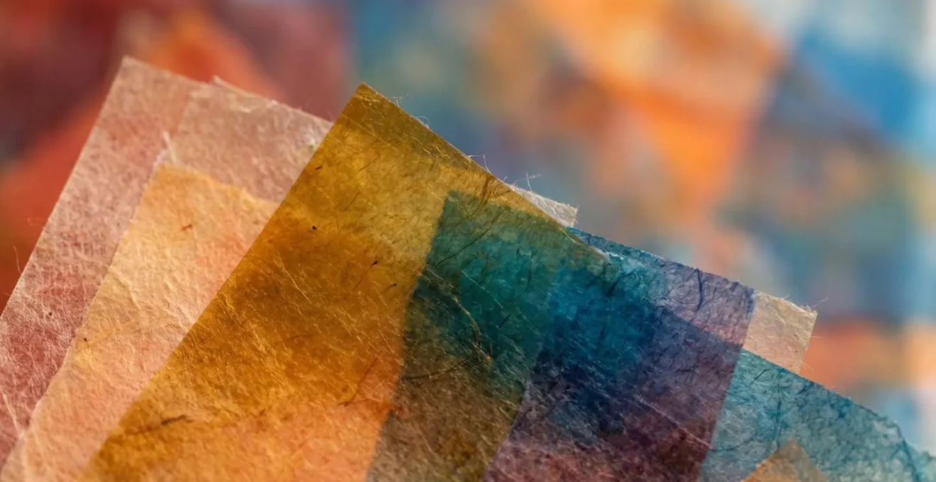 Macro close-up of layered translucent materials showing gradual tonal shifts and borrowed color elements