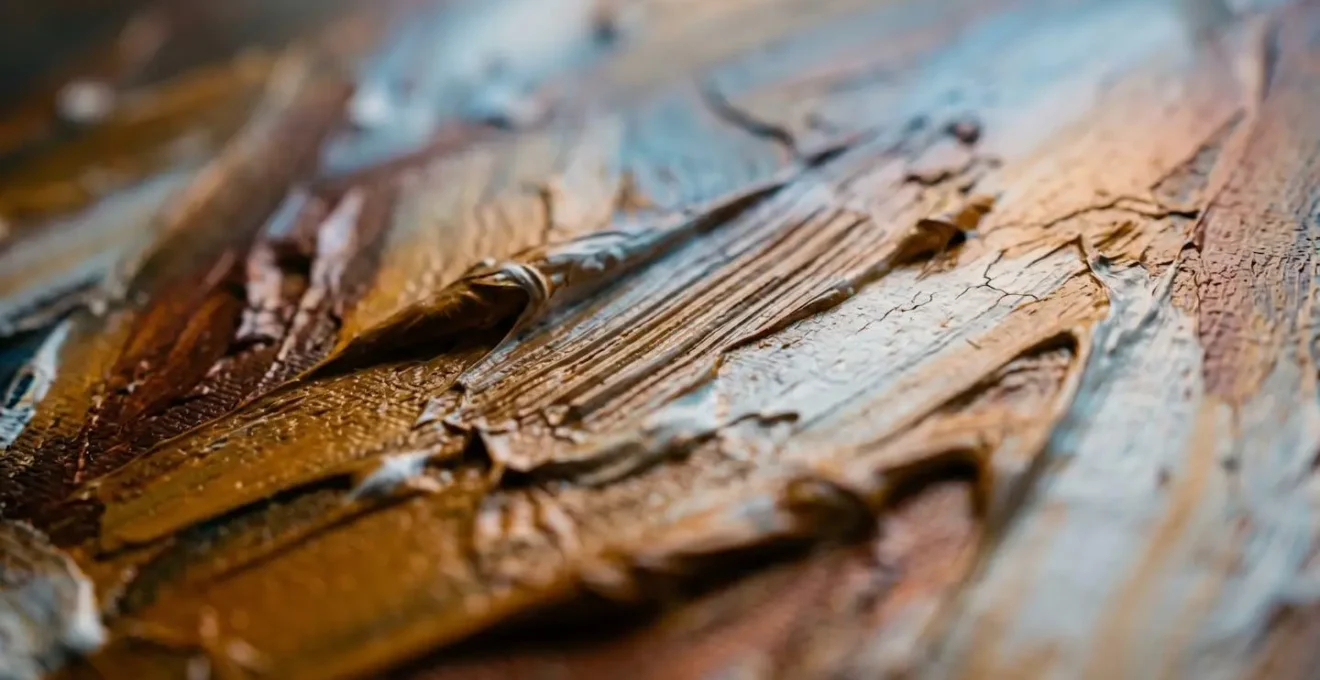 Close-up macro view of projected colored light intersecting with textured oil paint surface on canvas