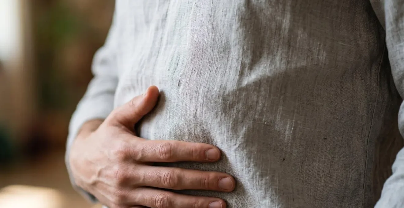 Close-up of singer's torso demonstrating proper diaphragmatic breathing technique for range extension